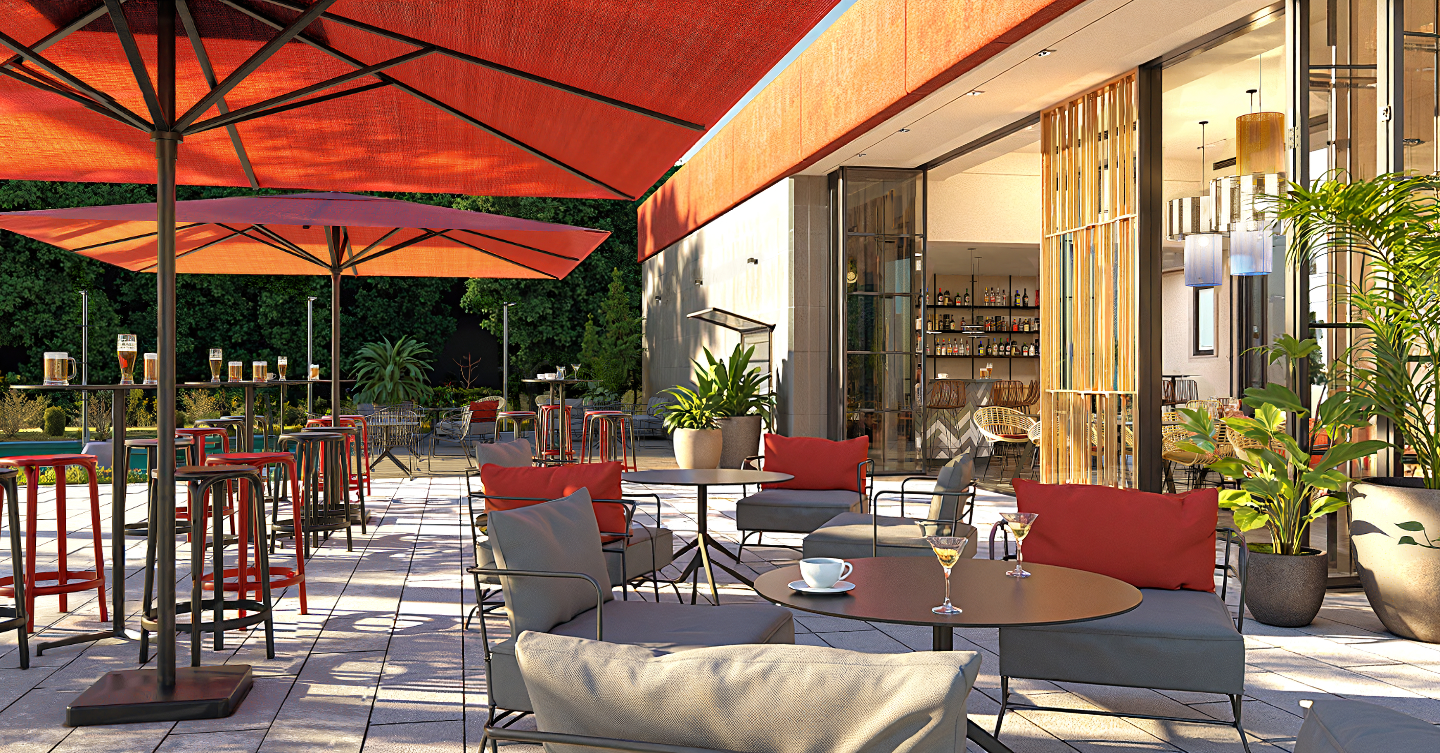 Central park entrance bar, with red parasol and metal furniture with red and grey cushions. Deep vegetation.